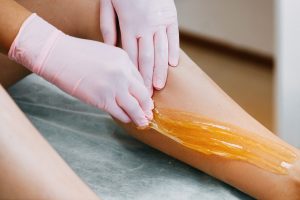 Sugaring Sugar waxing feet in the beauty salon. Depilation and beauty concept.